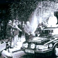 Rock Guitarist the late-Chris Rea (Driving Home for Christmas) launches the new Challenger SAAB in a shower of champagne. Edinburgh 1987